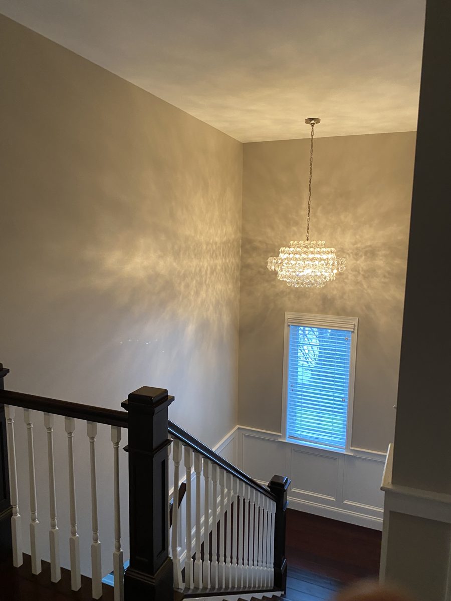 Painted stairwell and foyer with trim work